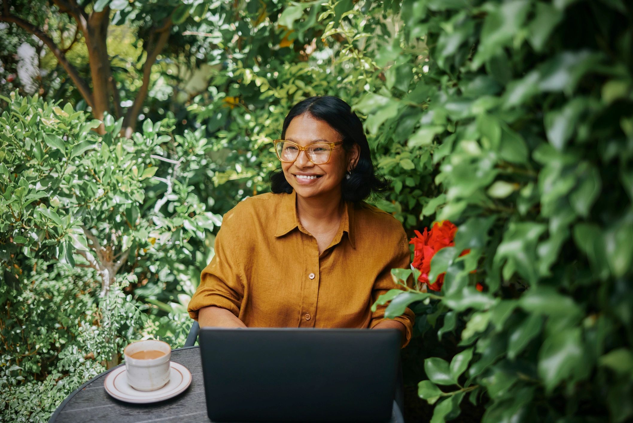Professional working outdoors with a laptop